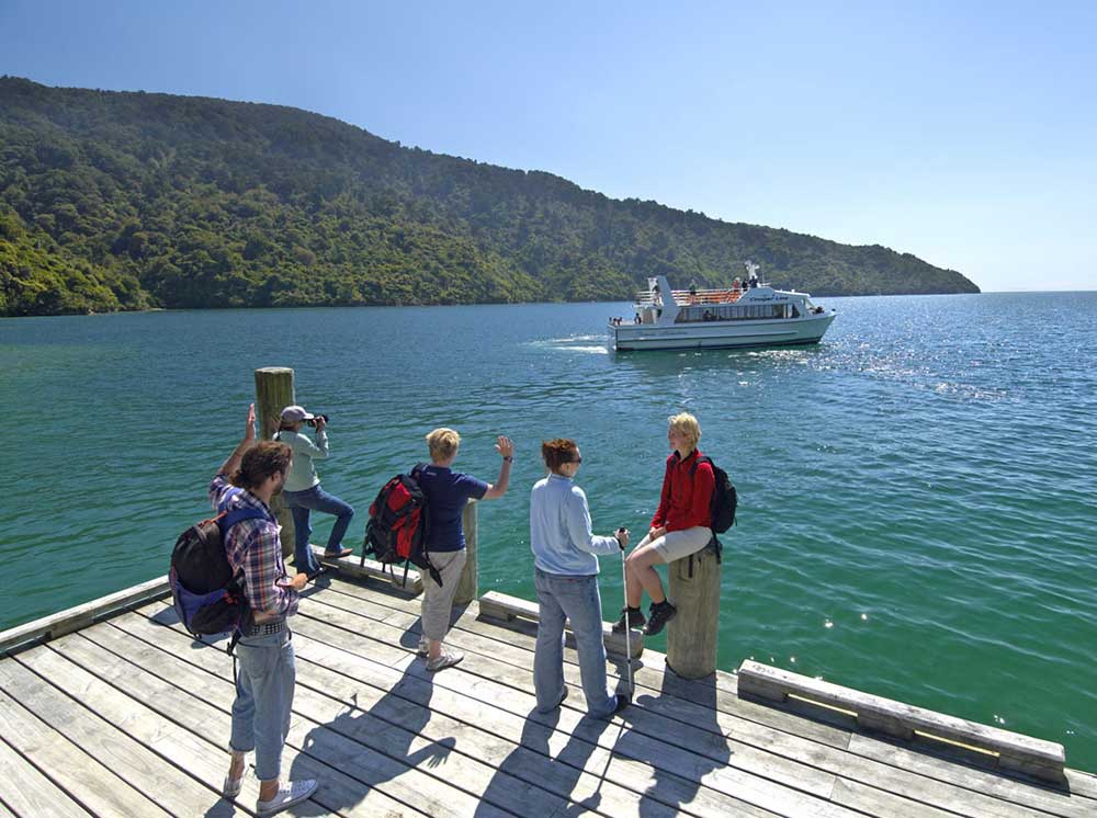 Walkers waiting for a water taxi in the Marlborough Sounds