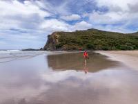 Walking barefoot on the beach in Northland