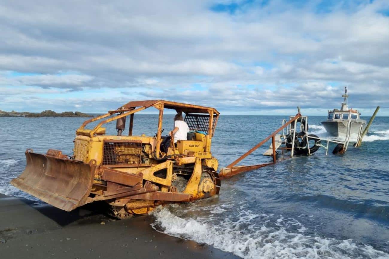 Boat approaching bulldozer and trailer at Ngawi